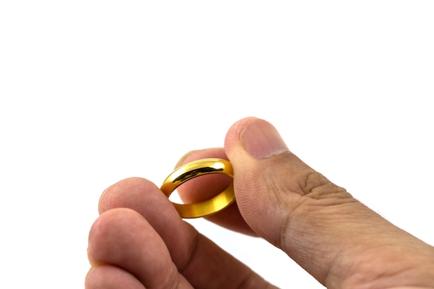 Closeup photo of  golden wedding ring on hands isolated on white background