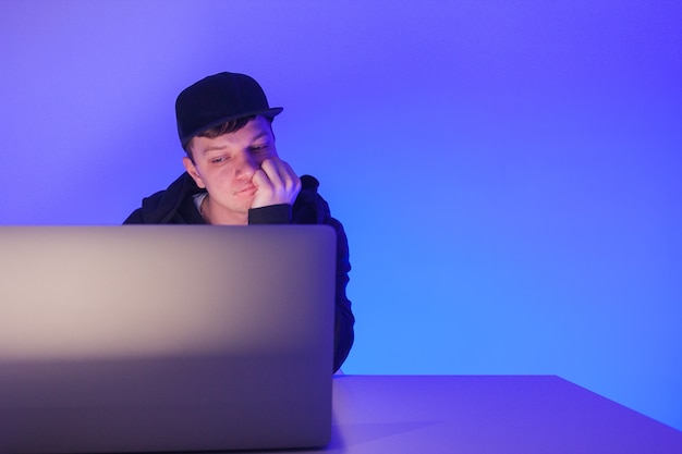 Closeup photo handsome man working on laptop with copyspace