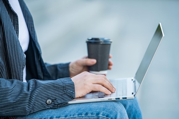 Closeup photo of man blogging online with computer man blogging online with laptop outdoor