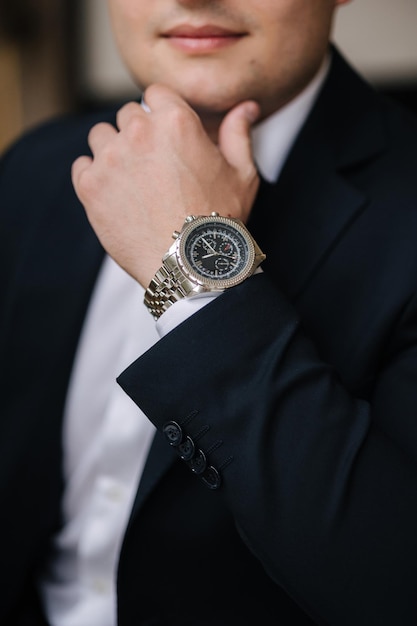 Closeup photo of man put hand on chin luxury watch on mans hand stylish look