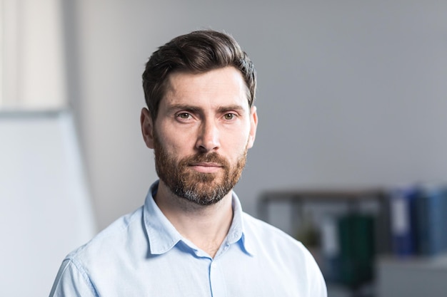 Photo closeup photo portrait of young bearded businessman man in shirt in office