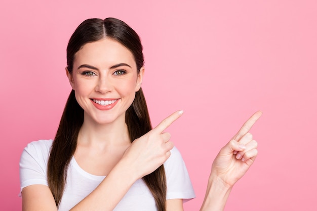 Closeup photo of pretty funny lady directing finger side empty space