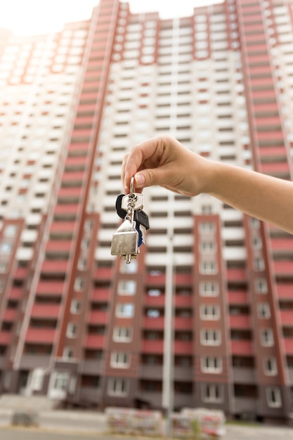 Closeup photo of real estate agent holding keys from new home