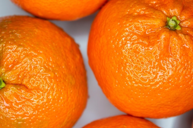 Closeup photo of ripe tangerine or mandarin fruits. Healthy citrus fruit.