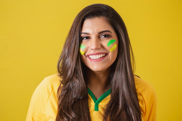 Closeup photo of Woman supporter of Brazil world cup 2022 soccer championship smiling