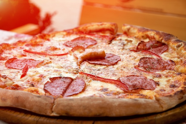 Closeup photography of fresh pizza divided into slicesFood backgroundOpen air cafe