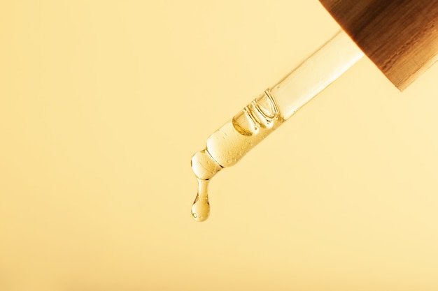 Closeup photography of the pipette with dripping oilZero waste wooden cover