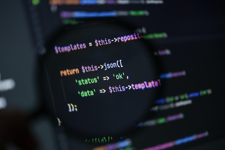 फोटो closeup of php source code showing json success response with status and data values under magnifying glass on dark screen background