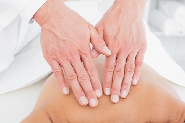 Closeup of a physiotherapist massaging womans back