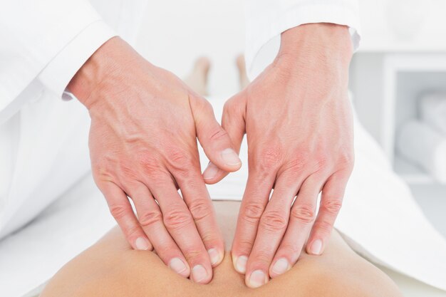 Closeup of a physiotherapist massaging womans back