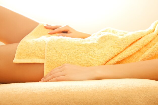 closeup picture of female hands and legs in spa salon