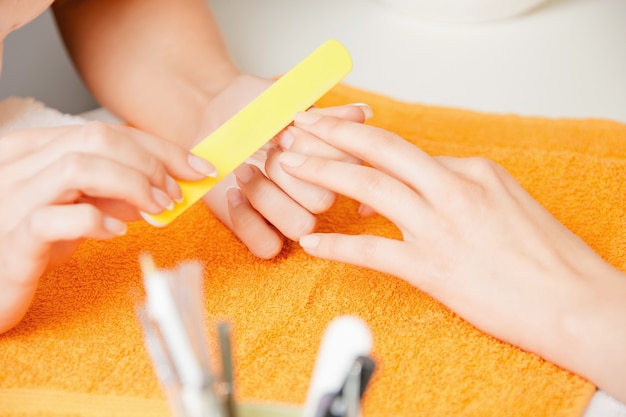 closeup picture of manicure process on female hands