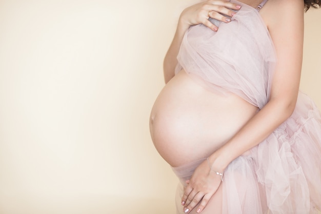 Closeup picture of pregnant woman. Unrecognizable expectant. Belly closeup.