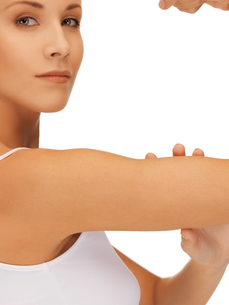 closeup picture of sporty woman flexing her biceps