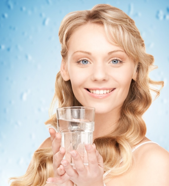 closeup picture of woman hands holding glass of water .