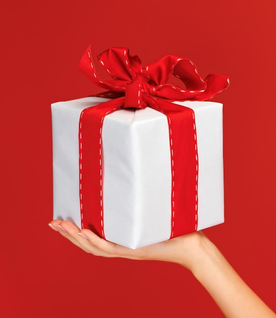 closeup picture of woman's hands holding a gift box