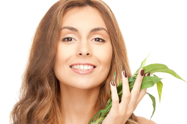 closeup picture of woman with green sprout