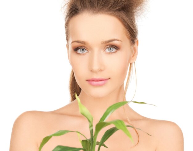 closeup picture of woman with green sprout.