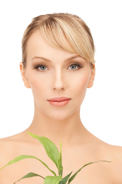 closeup picture of woman with green sprout.