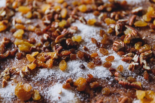 Closeup of pie filling ingredients with traditional winter spices like raisins pecan cinnamon and sugar