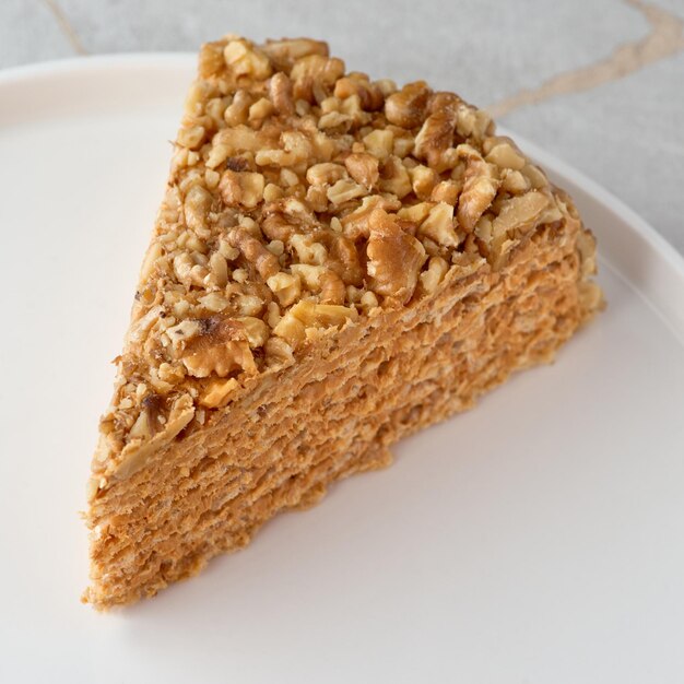 Closeup piece of cake with condensed milk on a white plate