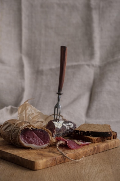 Closeup piece of jamon on fork light appetizer homemade food selective focus