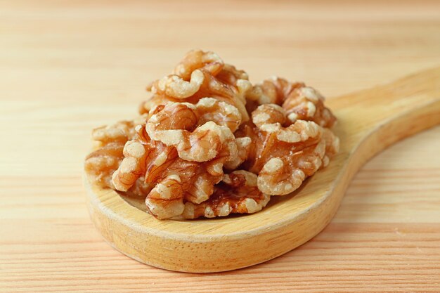 Closeup Pile of Walnut Kernels on a Wooden Spoon on Wooden Table