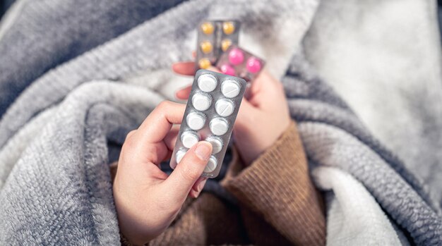 Photo closeup of pills in female hands top view