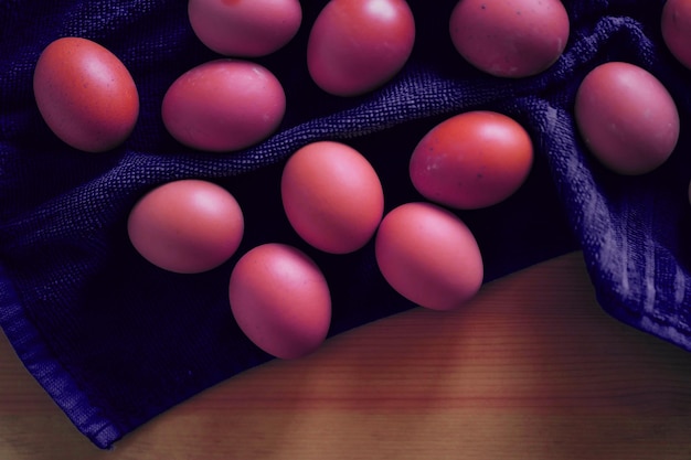 Closeup of pink colored eggs on a towel in the kitchen during the Easter holiday in the spring