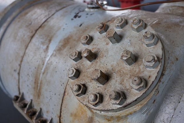 Closeup at pipeline valve which is using to control production process in the oil refinery plant sel