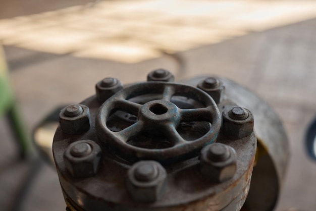 Closeup at pipeline valve which is using to control production process in the oil refinery plant sel