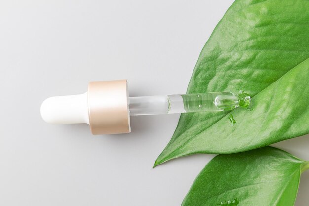 Closeup pipette with a hyaluronic moisturizing serum on a gray background Beauty skin care concept Beauty and spa