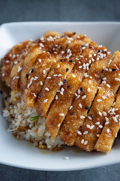 Closeup of a plate of battered chicken fried rice oriental cuisine