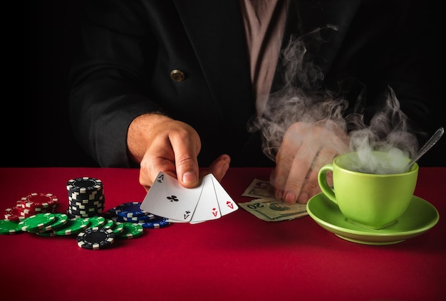 Closeup of a player hand holding playing cards in a casino