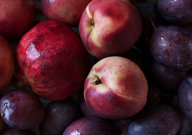 Closeup of plums and other fruits