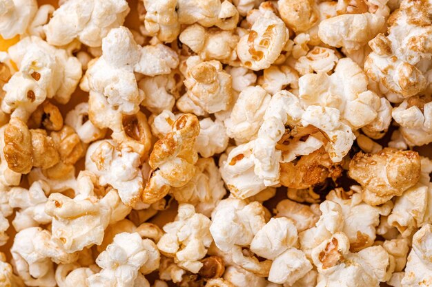 Closeup popcorn abstract background on yellow Copy space