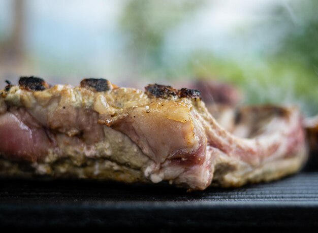 Closeup of pork ribs being grilled in the garden