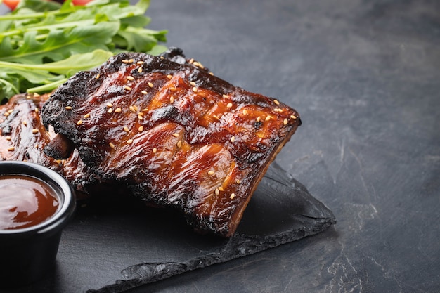 Closeup of pork ribs grilled with BBQ sauce.