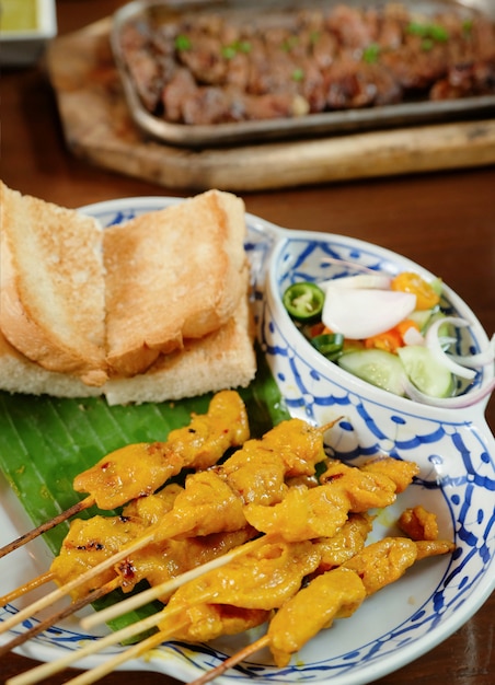 Closeup pork satay with roasted bread and sweet sauce