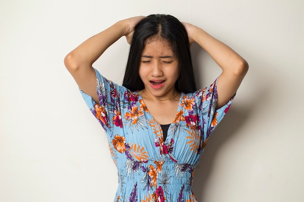 Closeup portrait of asian young woman scratching head with hand