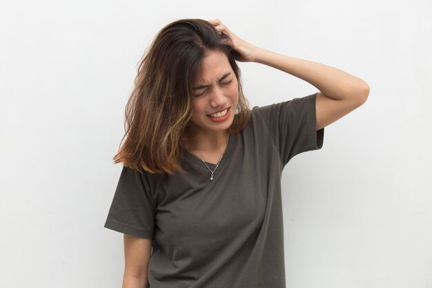 Closeup portrait of asian young woman scratching head with hand