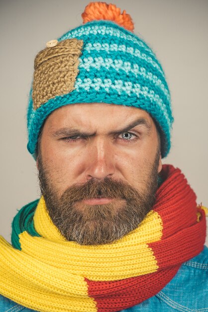 Closeup portrait attractive bearded man in warm knitted hat scarf health beauty and people concept