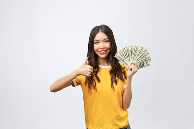 Closeup portrait of beautiful asian woman holding money