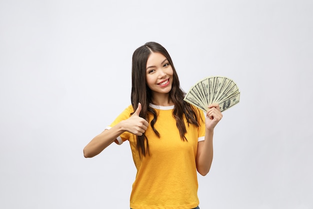 Closeup portrait of beautiful asian woman holding money