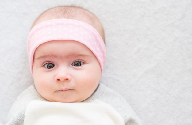 closeup portrait of a beautiful baby on bright background