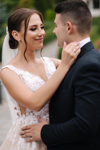 Closeup portrait of beautiful wedding couple walking outdoors groom and bride in the park