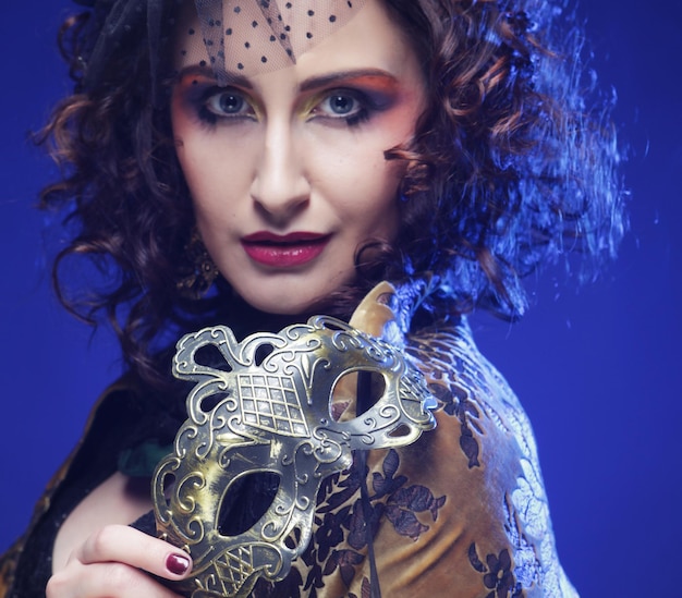 Closeup portrait of a beautiful woman with carnival mask