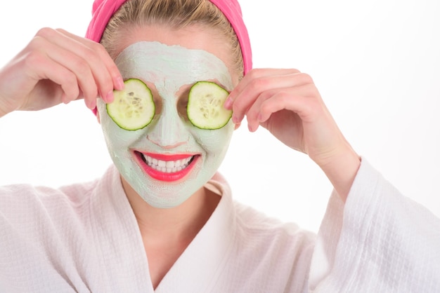 Photo closeup portrait of beautiful woman with facial mask spa salon cosmetic mask with cucumber natural