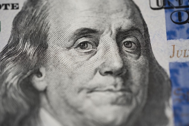 Photo closeup portrait of benjamin franklin on 100 bill