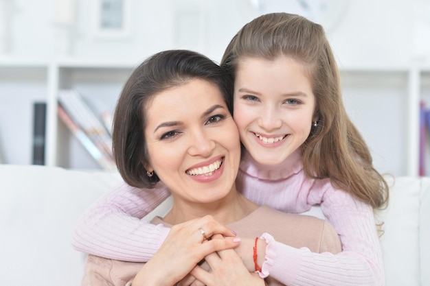 Closeup portrait of a charming girl with mom at home